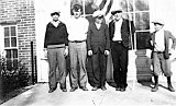 School boys raising the flag.  The boy holding the rope appears to be Robert Blumer.